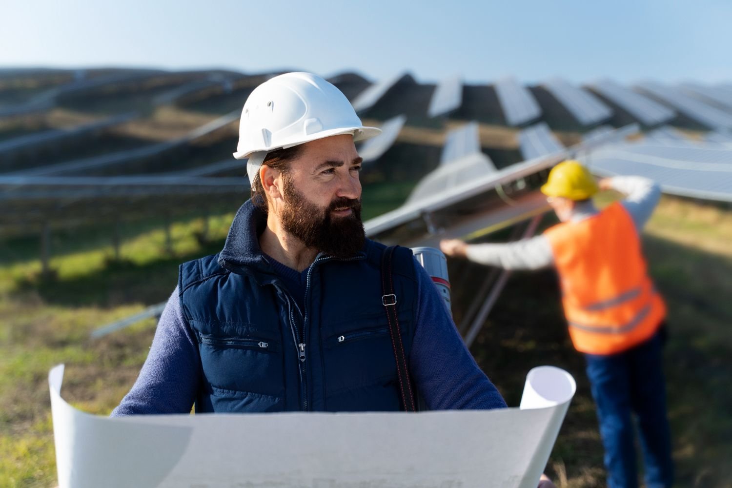 Engineers reviewing plans at a solar array